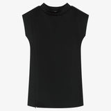 A structured black dress for girls with side openings, extended shoulders and a mock neck stretch